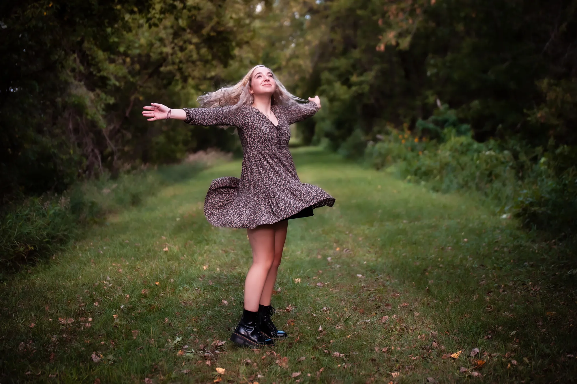Senior pictures in the Cedar Valley, twirling on a wooded path